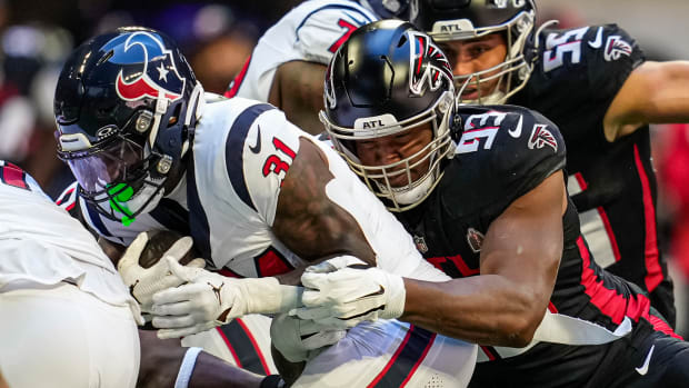 Atlanta Falcons defensive tackle Calais Campbell (93) tackles Houston Texans running back Dameon Pierce (31) during the first quarter at Mercedes-Benz Stadium.